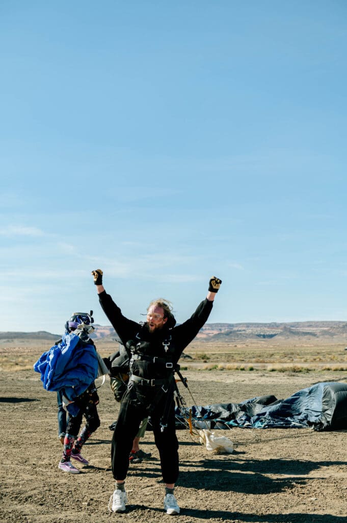 groom cheering after skydive during his Moab elopement